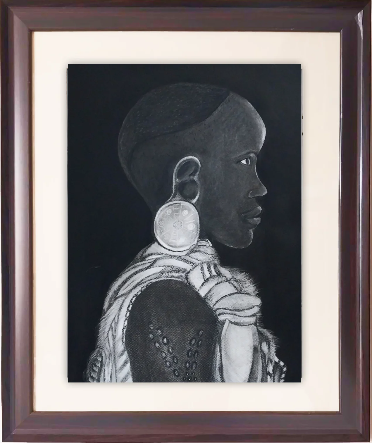 Charcoal portrait drawing of a woman in profile with a large carved disc earring against a black background