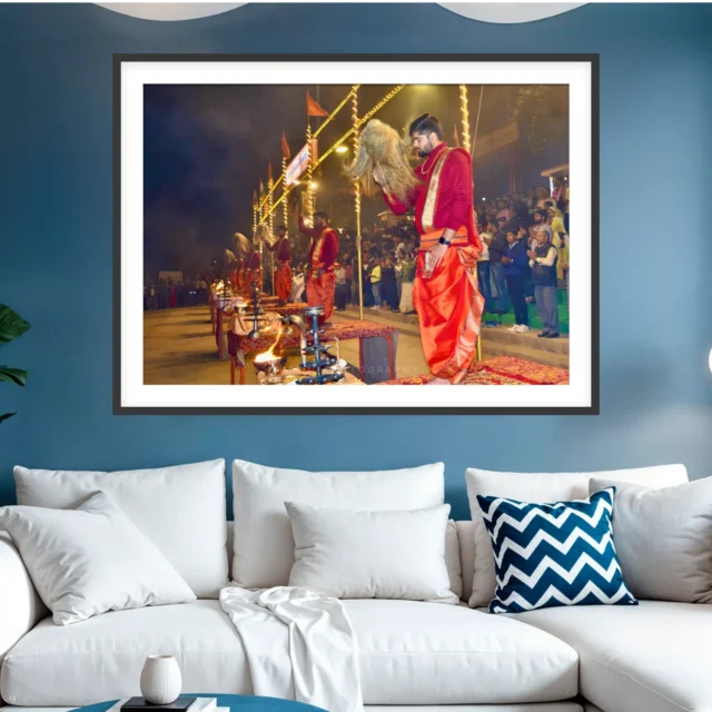 Photograph of priests at the Ganga Aarti in Varanasi sweeping chamars over brass lamp stands before a crowd at night