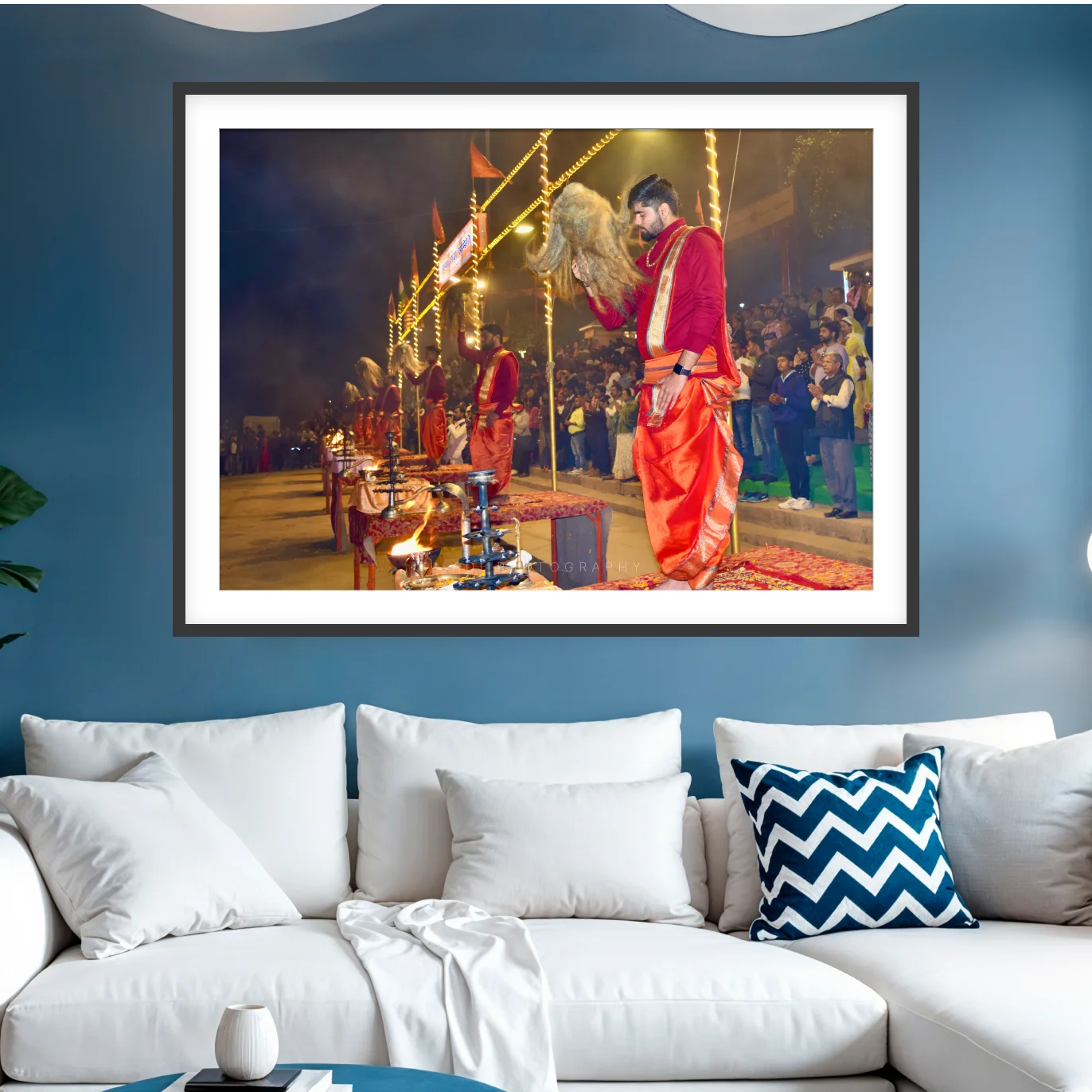 Photograph of priests at the Ganga Aarti in Varanasi sweeping chamars over brass lamp stands before a crowd at night