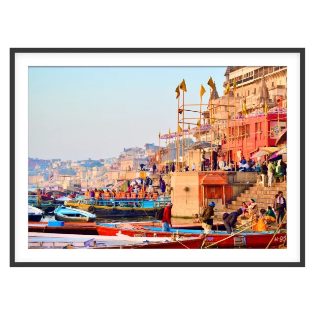 Varanasi ghats with colorful boats and historic riverside buildings along the Ganges