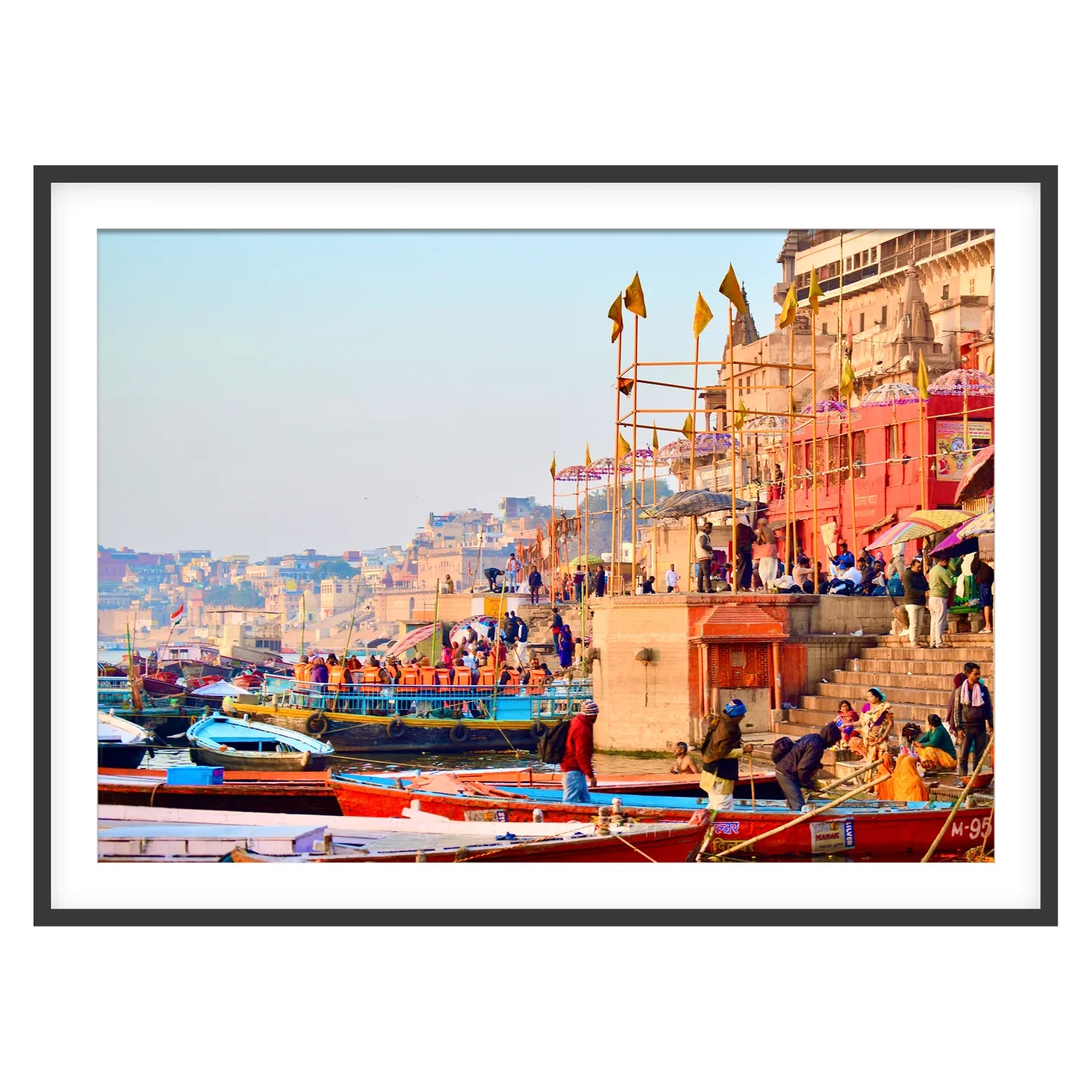 Varanasi ghats with colorful boats and historic riverside buildings along the Ganges
